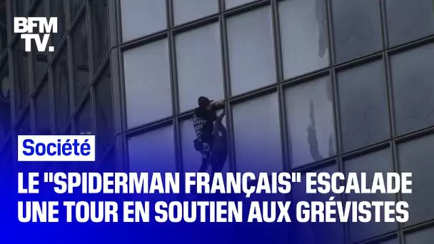 Le "Spiderman français" Alain Robert escalade la tour Total de La Défense en soutien aux grévistes
