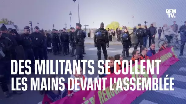 Des militants de Dernière Rénovation se collent les mains devant l’Assemblée nationale